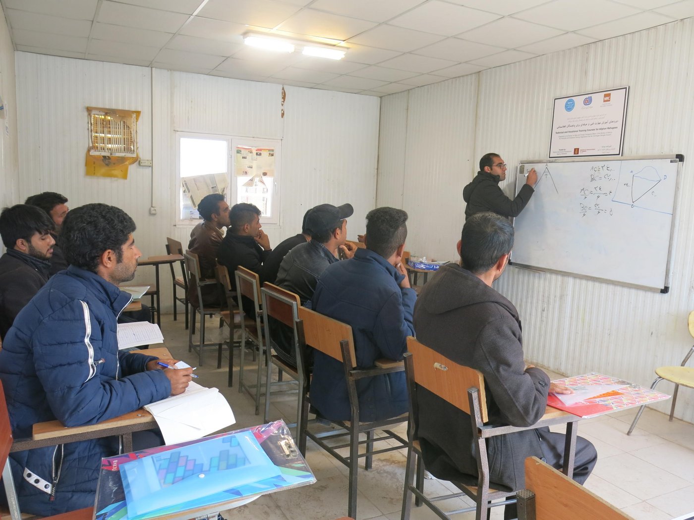 Afghan refugees attend a vocational training course on theories of architectural design at a settlement in Kerman, Iran. The training was funded by the Danish International Development Agency (DANIDA). Photo: Roya Maleki/NRC