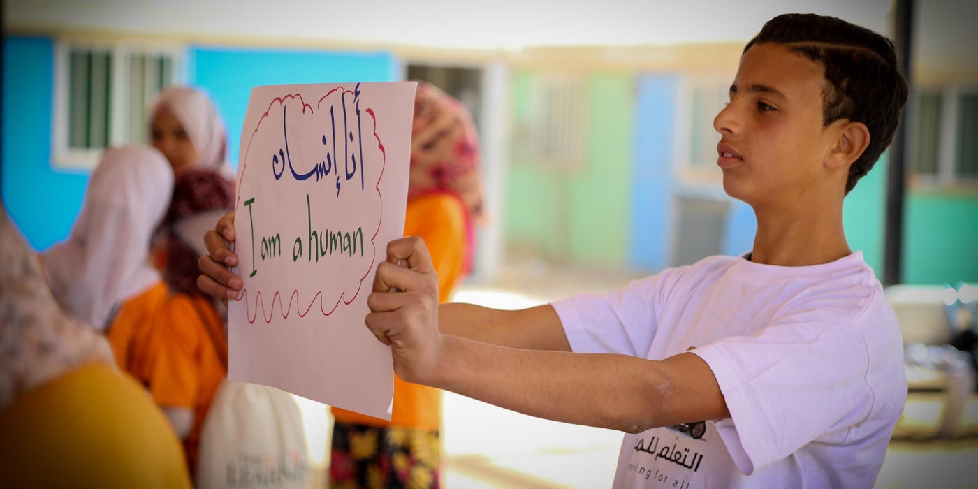 This card reads: "I am a human."
“I’m a child, I’m a human, I have the right to learn, I have the right to speak and express myself.” Words from children were written on sheets of paper for parents and local community members to read in an event held by NRC’s Education programme in Zaatari refugee camp, Jordan, to commemorate the 16 Days of Activism campaign, an annual international campaign to challenge violence against women and girls. The campaign runs every year from 25 November, the International Day for the Elimination of Violence against Women, to 10 December, Human Rights Day. (Photos by: Hassan Hijazi/NRC).