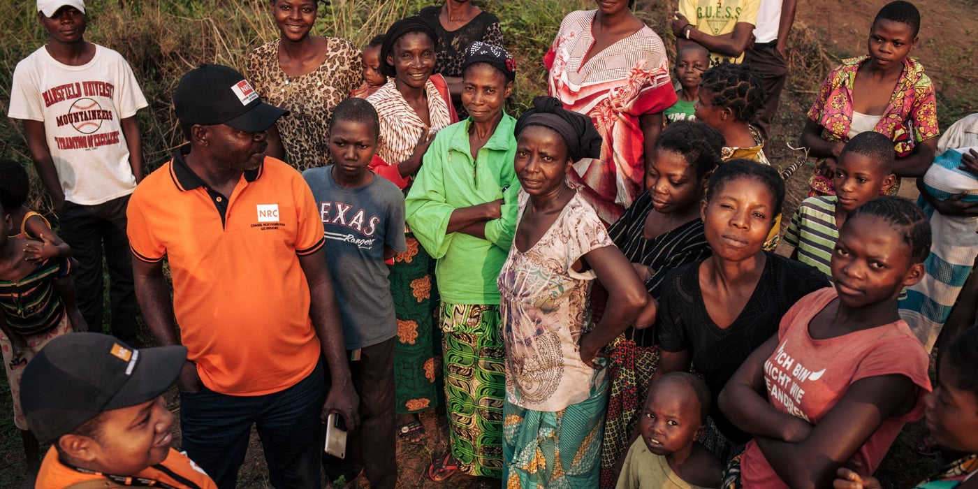NRC team meeting with residents of Mbulungu village.
Nearly 17,000 people—or close to 95 per cent of Mbulungu’s population was forced to flee into the forest when fighting broke out between armed groups in March and April of 2017. Some had to walk up to seven days to find a safe place to hide. Many lost family members, were assaulted and nearly starved to death while on the move. All lived in horrific conditions not certain of whether or not life would ever return to normal.
Though calm has returned to Mbulungu and several villages and towns just like it across Kasai-Central, people are not able to continue their lives as normal. The violent conflict of 2017 left mass destruction in its wake—homes, markets, schools, sanitation facilities and health infrastructure in complete disarray. In fact, 67 per cent of families living in Mbulungu do not have access to proper latrines and 55 per cent have no access to soap. These absence of these basic necessities coupled with malnutrition and lack of proper shelter can lead to a host of diseases and death.
For that reason, NRC visited Mbulungu, in early 2017, where they met with the community to understand their primary needs. NRC used its “community-based approach” by consulting with these communities to better understand their primary needs, to properly target the most vulnerable people and facilitate their ability to choose the assistance they require.
This intervention, however, is only a drop in the ocean of the vast needs of this community. NRC is currently the only humanitarian actor in the zone and funding is not enough to address other acute needs such as food assistance, household items and education. The Humanitarian Response Plan is currently only 25 per cent funded eight months into the year. Humanitarian capacity is critically low. If donors do not act now for the people of Mbulungu and for the rest of DR Congo, it will be too late.
August 29, 2018, Kasai-Central Province, DR Congo.
Photo: NRC/Aléxis Huguet