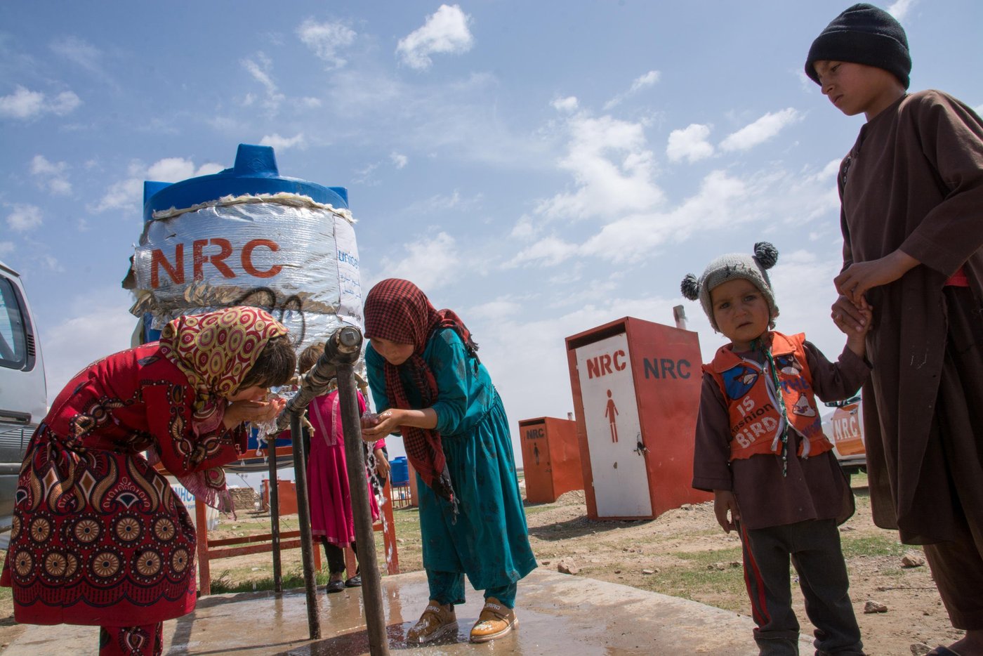 Norwegian Refugee Council (NRC) with support of the European Civil Protection and Humanitarian Aid (ECHO) supported the education program in the informal settlements in injil district of Hirat.
Through a six-month grant from - December 2018 to May 2019, (ECHO) contributes to NRC Afghanistan’s ongoing education programme to further its reach and increase its positive impact on student beneficiaries through improved access to quality education in a protective environment.
This program is carried out through establishment of learning spaces, recruitment and training of teachers as well as provision of education materials to facilitate the learning process.
NRC’s Herat Education team along with its WASH & Shelter program installed 20 educational tents (five tents in Shahrak e Sabz and fifteen tents in Faiz Abad) in Injil district of Herat.
Shahrak-e-Sabz is a new location for the displaced community as the families were relocated due to land tenure related problems in December 2018. Currently up to 500 HH are living in this site.
For each education tent, NRC provided two latrines (one female and one male), a 2,000 litters-water tank with stand, a latrine cleaning kit, and a hygiene kit. All education tents have been equipped with heaters during the colder winter months.
During selection of EiE learners, NRC used vulnerability criteria to select priority students. This included out of school children, and children from those households that being targeted and supported through other NRC’s different program interventions. The students are mainly from Shahrak e Sabz and Kahdistan IDP settlement. Due to the high number of displaced families any more children than initially anticipated are now learning as part of NRC’s EiE proprgamme.
Currently, there are 535 (273 girls & 262 boys) students attending in 14 classes (5 tents) in 3 shifts. In each shift, there are around 38-40 students attending classes.
Students are mostly Pashto speaking and Hirat is mainly a Dari spoken province.
Since EiE aims to empower displaced children with local language skills and to promote the social integration, NRC worked with a skilled curriculum developer to prepare a specific module of Dari conversation, stories, and vocabulary. Beside this, education has psychosocial support and BLP training to enable students to learn the stress release exercise and techniques. And assist them to be more focused and happier in their classes as well as their studies.
Some of the students were in school before the displacement and have studied as high as seven grades. Since the public school is far from the informal sites, families don’t allow their children, specially the girls, to go to the public school. Getting admitted to the public school can be difficult because the students lack identity cards and documents from the school in their place of origin. Also, thousands of families have arrived in one location and the current existing schools don’t have enough capacity to enrol new students.
Photo: Enayatullah Azad/NRC
