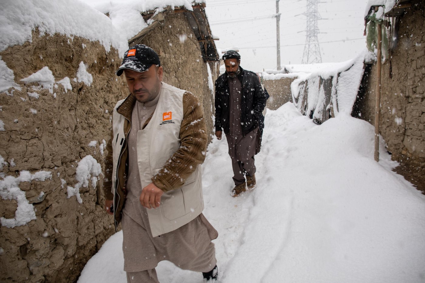 NRC shelter and WASH team doing a walkabout in Hiwadwal IDP Settlement in Kabul on a snowfall day. It’s first winter snow in Kabul and thousands of IDP families are living in substandard makeshift making them disposed to freezing temperature. Photo: Enayatullah Azad / NRC