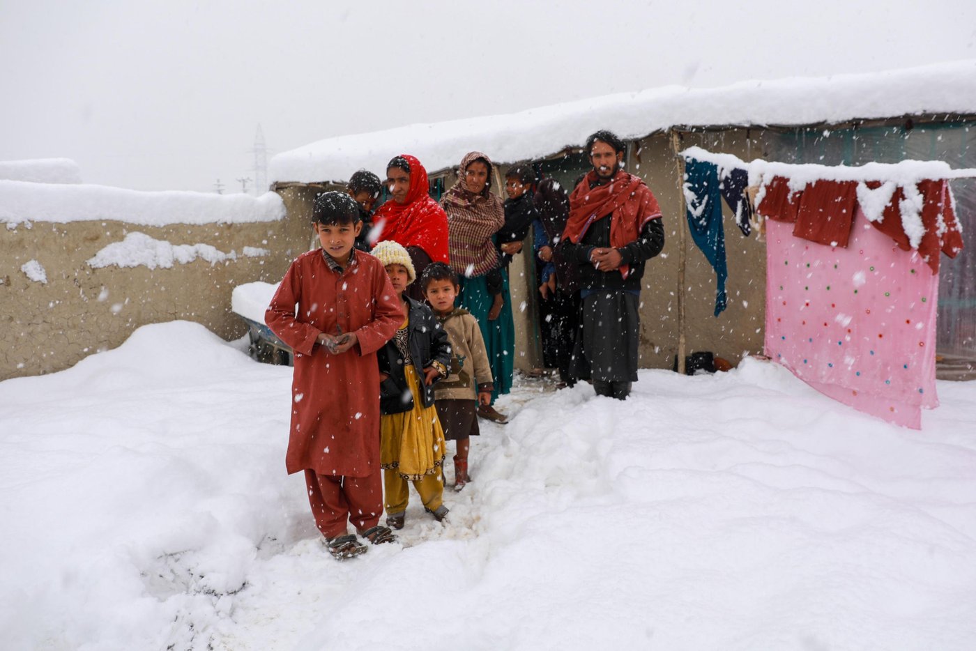Shahnaz makeshift home collapsed under the weight of heavy snow in an informal settlement in eastern Kabul this week. The family is now forced to live with neighbors as the temperature drops up to -20C during the night.
Shahnaz, 34, a widow was sleeping with her three children when the roof of their substandard makeshift home fill in onto them and now, she stays with three other families in shared two-room house in the camp.
“We were in deep sleep when the beam broke and the roof collapsed over us. I grabbed my children to protect and start shouting then the neighbors rushed to help us,” Shahnaz said. Several makeshift homes have reportedly collapsed during the last snow fall and many families are either staying with neighbors or with relatives. NRC with support from donors, German Development Bank (KFW) and Danish International Development Agency (DANIDA) improved and upgraded 330 shelters and built another 154 permanent homes across the capital, Kabul. Our team have observed that many of these upgraded homes are hosting more than one family.
Shahnaz and her three children are now staying with one of the neighbors. “Thanks God, we are not alone here and if the government is not being able to support us, the people do care about each other with their little in hand,” she says.
The mother says she begs on the streets to protect her children. “The two biggest challenges we were facing was food and the cold and now, shelter is also included on the list,” she added. Photo: Enayatullah Azad / NRC