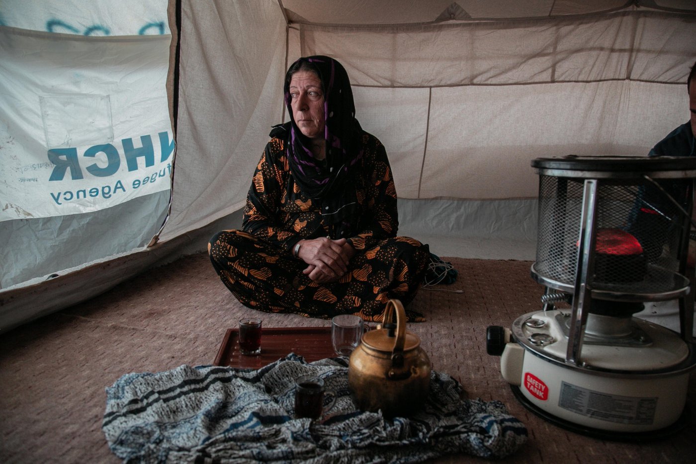 Sorya Ahmed, 55, a grandmother from Ras Al Ayn. When Turkey announced their military operations in north east Syria she moved to different locations hoping that the situation would calm down, however things were escalating and the fighting was reaching them from one village to another. Eventually, Sorya and her family decided to leave Syria and seek refuge in Kurdistan Region of Iraq. Sorya has been displaced three times during eight years of war but this time was more horrifying than any time before.
“We saw people burning in front of us. We escaped running over their dead bodies, there were no safe routes to escape, and they did not secure a road for civilians to leave.”
“We were 23 people; there were kids, women and young men with us. The smugglers were asking for a big amount of money. We did not have any money but we had my son's car, so we gave them the car instead of money.”
“At the border, we walked for around six hours. We were so scared that ISIS or anyone else would attack us. All of these children were with us without water and food.”
“On the way, we did not know who we are dealing with. Even men started to get scared because we no longer knew where we were going.”
“There is nothing to go back to, they burnt my house, and in Ras Al Ayn the original people of the area have left (now is full of Arabs and people from other areas). Even if I eat soil here I would not go back to Syria.”
Photo: Alan Ayoubi/NRC
Date: 02 December 2019