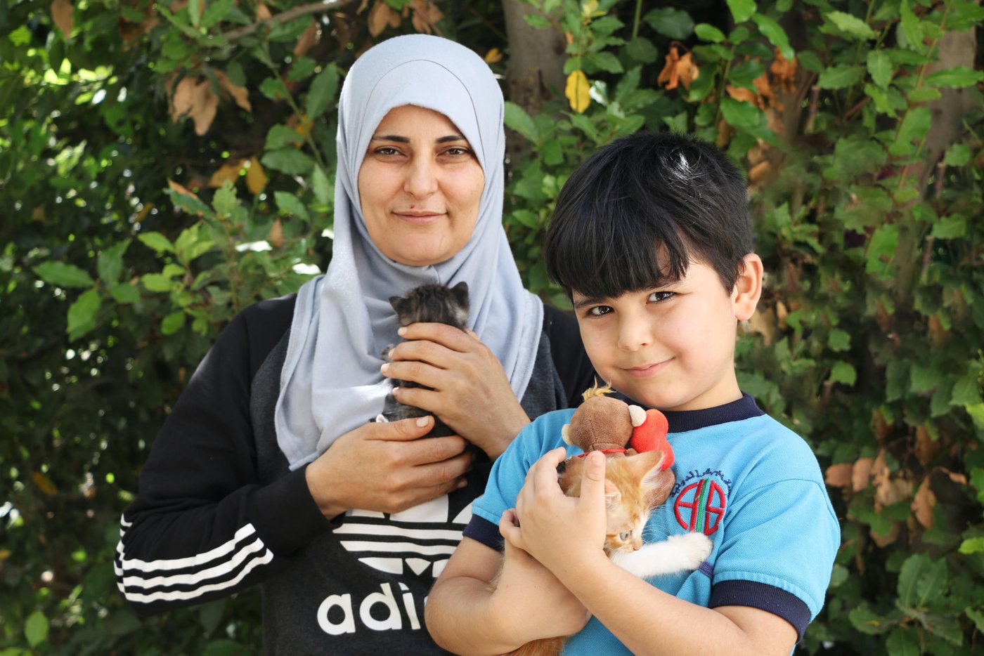 Samira, 35, a Syrian refugee who lives in Lebanon.
Cat name: Lili
“I decided to raise cats at home to make my two sons feel better, they suffer from a neurotic and mental illness. Raising cats at home is expensive, they need a special food, and other requirements. However, my children happiness is a priority for me, no matter how much it costs.
My sons asked me to get them cats, and I noticed that this might support them emotionally. My son, *Ahmad, is obsessed about animals, he would enjoy living in a jungle. He also asks me to get dogs for him, he likes to raise animals that cannot live here in the house, and once he asked me to get him a bear!
Raising kittens is more challenging than raising big cats, the kittens need more care and attention. After raising a good number of cats, I acquired a good experience in raising cats, I watch YouTube videos about cats and birds. I have information not only about cats, I have information about %50 of the animals, even *Ahmad, my son.
Once I had a competition here with my neighbor, he made an electronic eggs’ hatcher and I made a manual one, the one I did succeed and his one didn’t. I am very obsessed about everything related to animals.”
Photo: Nadine Malli/NRC