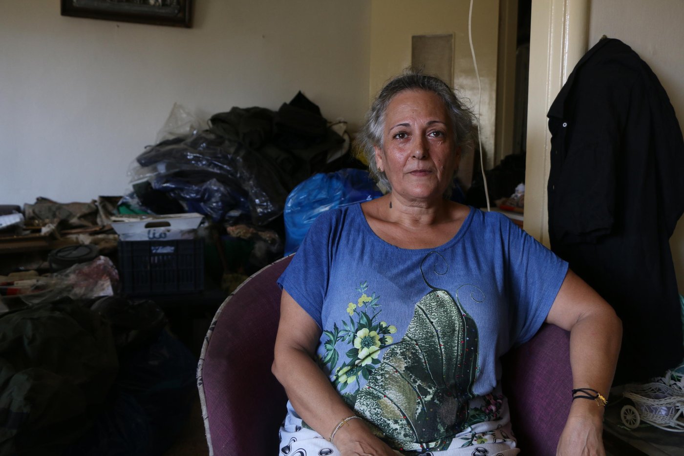 Fadia and 7 family members were sitting in the living room when the explosion happened, "I can't describe the sound that we heard, I tremble every time I remember this horrific experience, it was so scary, we were thrown around the room, the smoke covered everything, my daughter who is 20 years old tried to cover her grandmother with her whole body and this caused her back to become severely injured", Fadia says, "The next day we came back and with the help of the volunteers, we were able to reduce the damage and clean the house. I can't see any future in this country, I never wished for my daughters to travel, but now I'm encouraging them to leave this country and seek a better life", Fadia's daughters were affected psychologically by this explosion, they spend their nights crying, I'm now seeking professional help for them to recover. Unfortunately, we became displaced in our own country". Fadia concluded.
Photo: Zaynab Mayladan/NRC