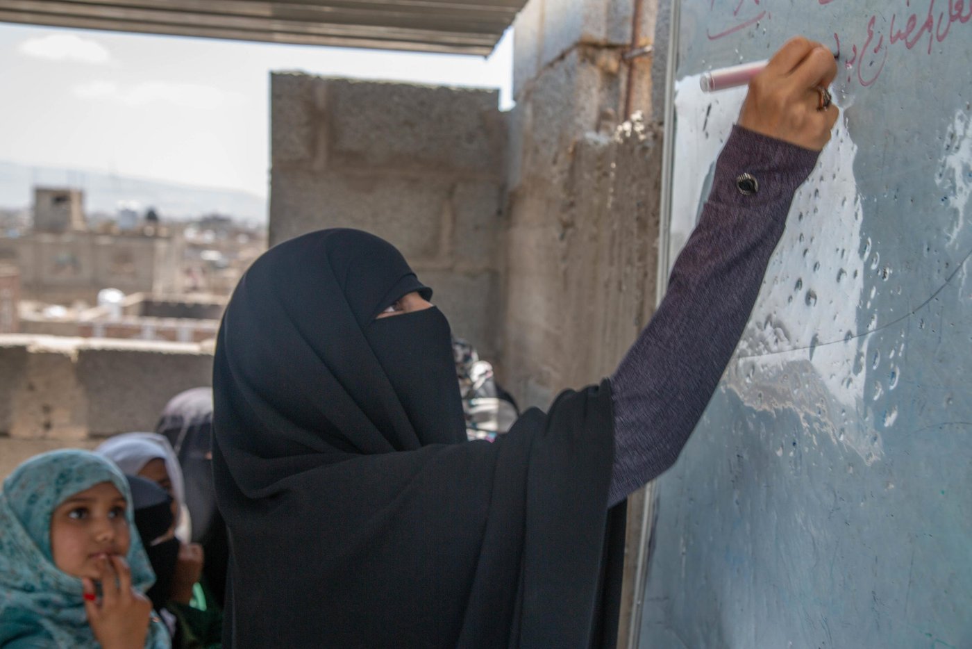 Rahma Ahmed 32 years old a teacher at Yemen Al-Mustaqbal school in Sana’a – Bani Al-Harith district.
Rahma teaches Arabic lecture, she started her career in teaching since 2012 as a teacher. Her life was stable with her husband and her child Mohamed, 10 yrs. Before the conflict started, Rahma and her husband were able to afford the daily needs as the income could cover the house rent and food.
Since the conflict started, education sector in Yemen collapsed, Teachers who have not received regular salaries for two years, can no longer meet their most basic needs and have been forced to seek other ways of income to provide for their families. Rahma one of the teachers who haven’t received a salary and she could stay seeing her son starving after her husband also left them because he could not afford anything for them. Rahma has skills on drawing, an alternative way to get income she draws scholastic arts and sells them for schools in a nominal amount 400-500 Yemeni Rial which’s (1$) per piece.
“Before the war, we were receiving salaries, somehow it’s little but at least we can afford everything as prices were affordable. But now no salary and if we get the same amount of salary it will not cover 50kg of wheat… it's nothing.”
“Sometimes, I borrow money to get my son a sandwich for breakfast and some stationary for my son, I want to keep him motivated after his father left us. I don’t want to destroy his future.”
“I use my skills on drawing to draw scholastic arts for the schools, I get around 1$ per piece, it not much, but I love doing it”
Despite all the challenging she faced, Rahma continues going to school and teaching the students. Her motivation is to educate the next generation who’d build her country and she believes that it not fair to let those children without education.
“The motivation to come to school is to educate and build the next generation, and it’s not fair to let Yemeni children without education no because of the salary, the salary is nothing. I want also to keep my son motivated to not leave the school.”
Rahma sees the students suffer the most, the student behaviors changed because of the war and the students become more violent and aggressive, in addition to that some of her students cannot afford the transportation or breakfast, they sometimes come to school hungry which make them unable to comprehend the classes and some cases fall down during the day because of hunger.
“I remember one of my students has fallen down because she did not eat breakfast and she cannot afford”
“I can see also some student cannot be active in the class because they eat only one meal per day according to my discussion with some students.”
“Students also traumatized because of the war and they can no find a safe place to study.”
Rahma’s son Mohammed 10, years old, 5th grade, He is the only child for her. Raham takes Mohammed every day with her to the school to save more money even if she has no classes to teach, they go together to the school to by walking. The school is one kilometer far away from the school it exhausting for her son.
“I take my son every day with me to the school, in order to save some money, we share the breakfast together even if I don’t have classes I stay until he finishes.”
School situation
The school is a poor condition, small and it hosts more than 1500 students. The school building is basically a rental house and it has no school facilitations or yard for students. In addition to small classrooms with almost no desks. Some students take their classes on the roof of the school building due to a shortage of space.
“The building is a poor condition; the classes are small and student set on the ground. The affect negatively on students. Some of them the study on the roof under the sun.”
“The fear also from the diseases, the crowded place could be a place for spreading the disease.”
Rahma’s dream is to become an artist, she wants to sell her artworks to help vulnerable people in Yemen and help them to get medical treatment. Also, she wants the war to end
“I want to become an artist so that I can sell my arts and give the money to people in need especially who need medical treatment that causes by this war.”
“I wish the peace returns back to my country. I don’t want to see children’s future unknown.”
NRC is responding to Yemen Al-Mustaqbal School with European Union Humanitarian Aid fund by building new classrooms and desks, in addition, to conduct training for the teachers and creating temporary Learning Spaces (TLS). The students will be able to move the new building in the coming school year.
“Thanks for the donor, we are really excited to move the new place, I am sure that the new build will be a motivation for the children and change to their behaviors.”
“Students will have a place to learn and play, the new building has a lot of facilities that would help students to have a quality education.”
Photo Credit: Mohammed Awadh/NRC