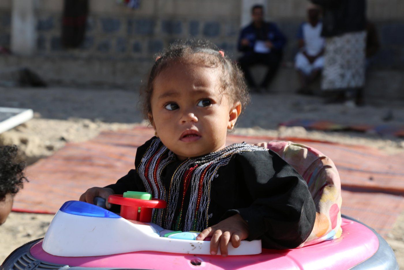 Lailah Rabei Al-Raboui, one-year-old, playing in the yard of Al-Fajr Al-Jadeed School where her family has been living since 2015 after the war forced them to flee their houses in Taiz city.

Photo: Nasser Abdulkareem/NRC